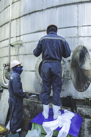 Male into the manhole  tank stainless chemical area confined space safety blower fresh air